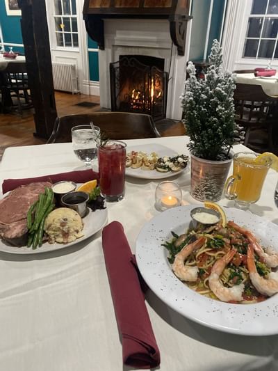 Dining table near fireplace at La Tourelle Hotel and Spa