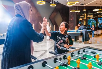 Son and a mother playing foosball at Bay La Sun Hotel & Marina