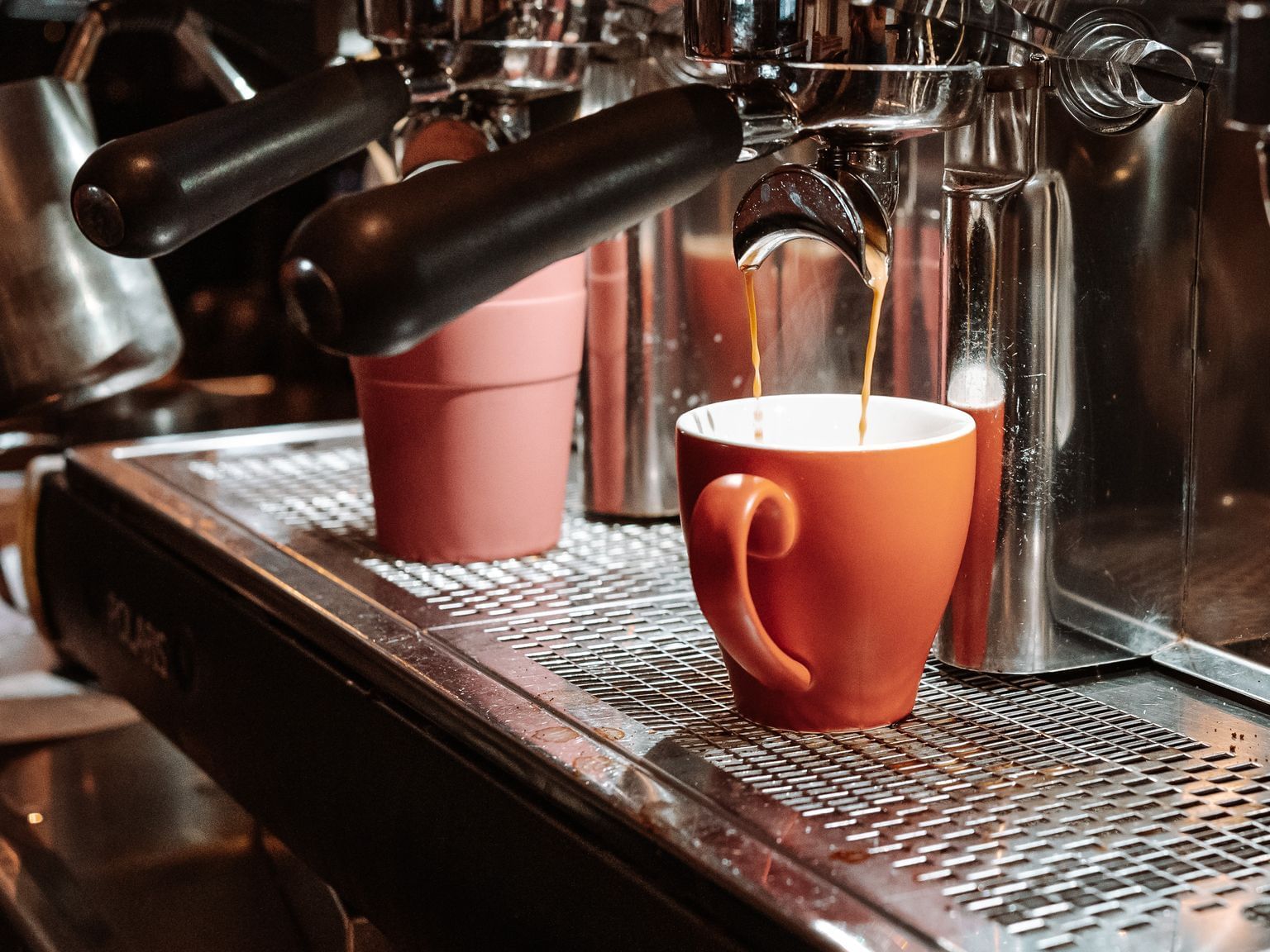 Close-up of pouring coffee from a coffee machine at Grand Chancellor Hobart