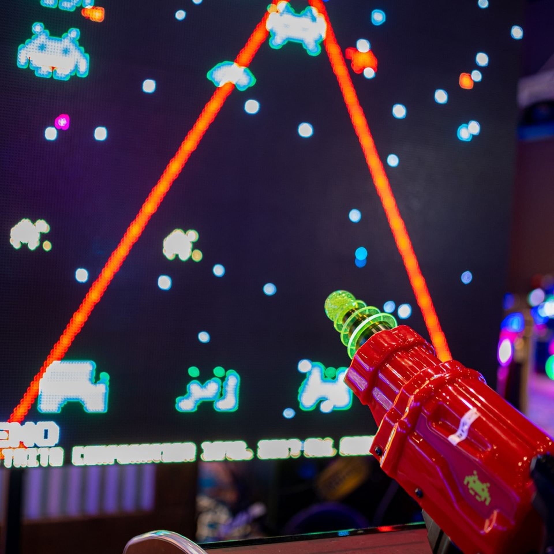Close-up of a red laser blaster being used in an immersive electronic game at Margaritaville Resort Biloxi