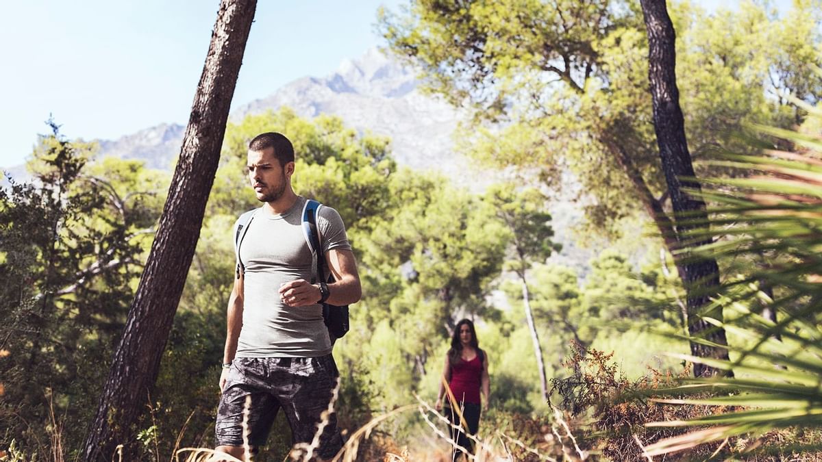 A couple on their way to hiking near Marbella Club Hotel