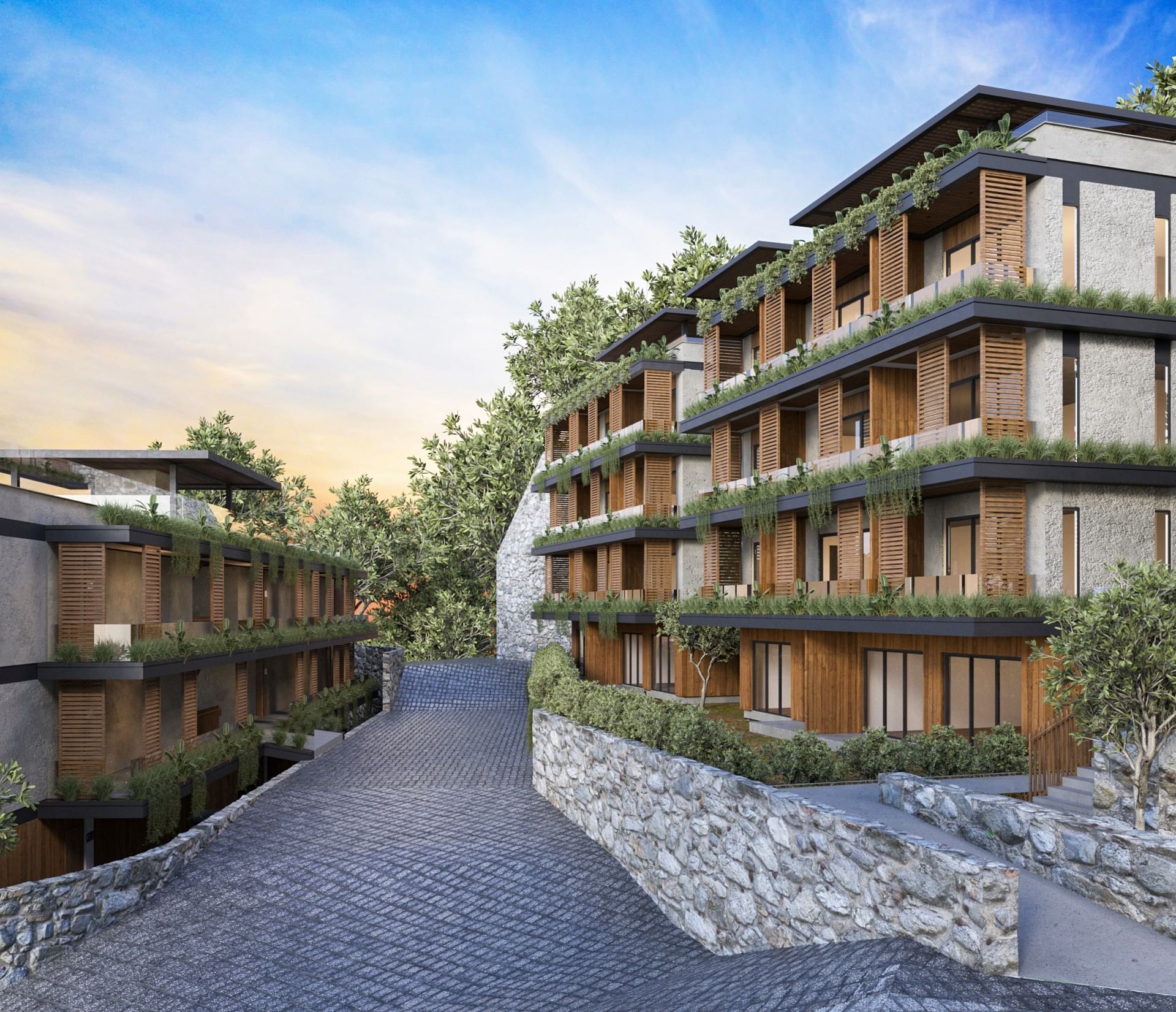 Beautifully terraced BlueZone Residence buildings at A'ila Residences, with lush greenery and stone walls