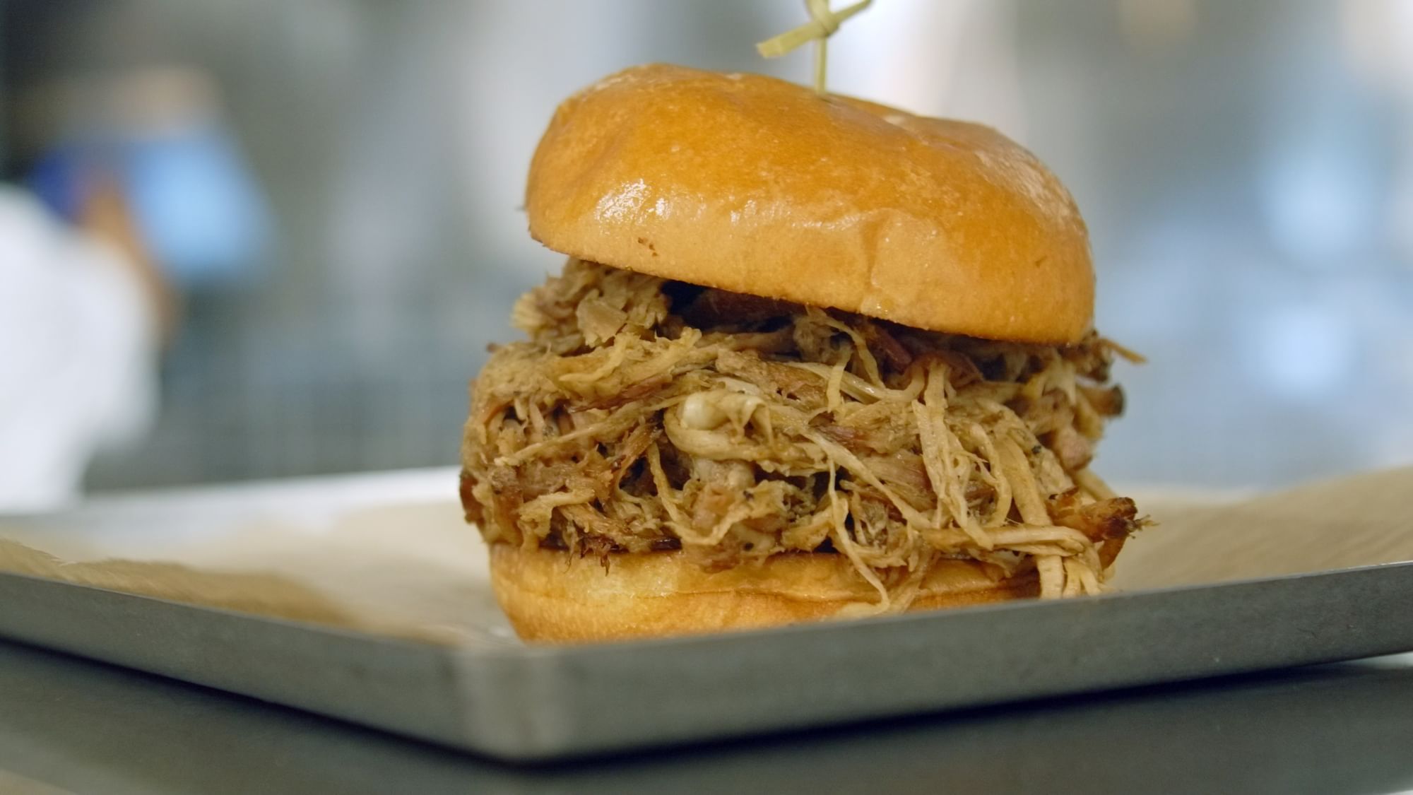 Close-up of a pulled pork bun served in Bark ‘N Brine at Camp Creek Inn