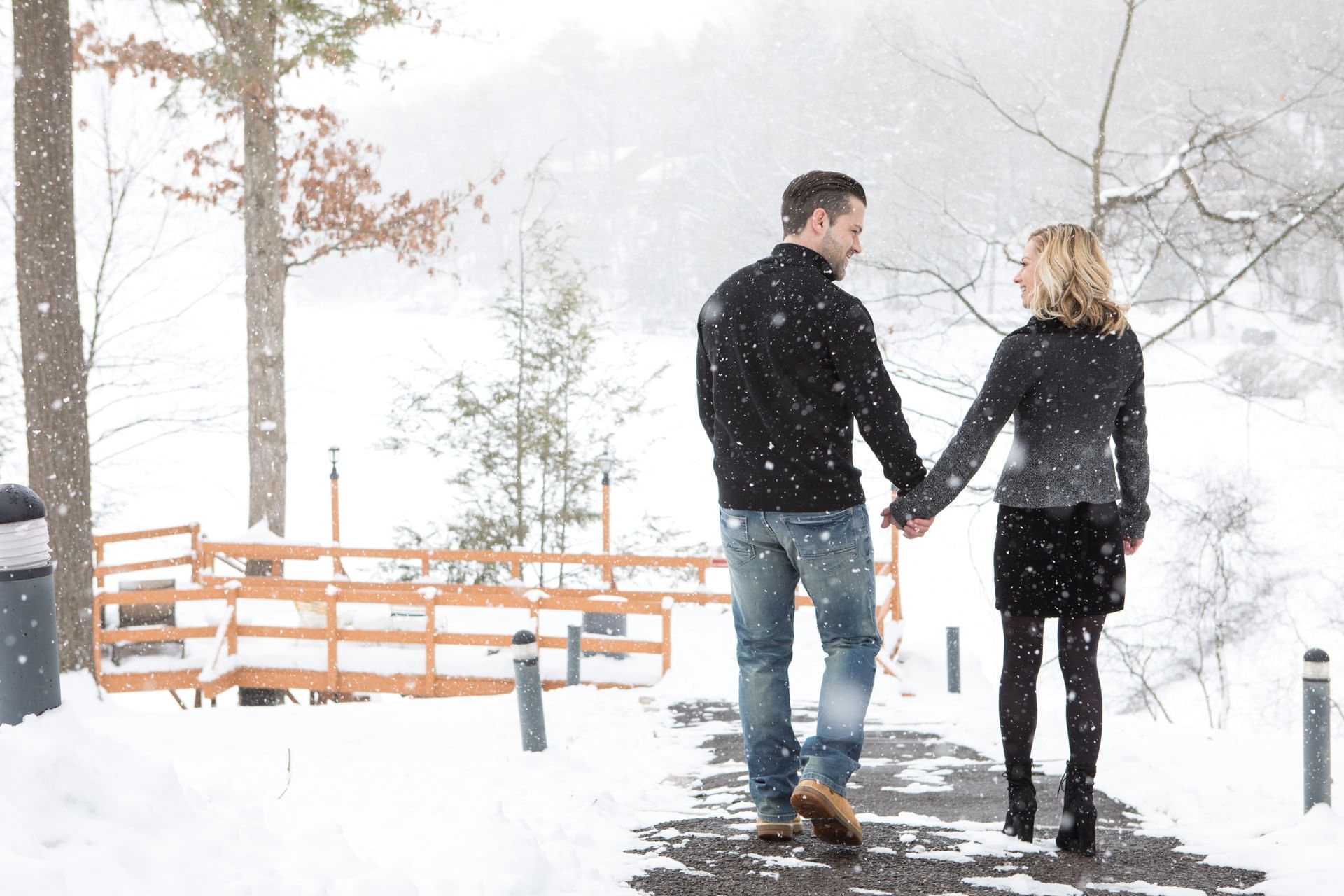 Couple walks hand-in-hand along a snowy path near Cove Pocono Resorts