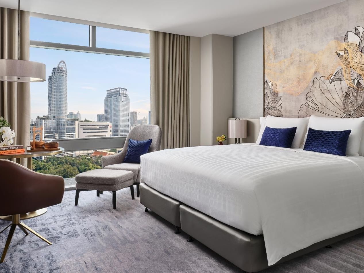 Bedroom with city view in Executive Suite at Chatrium Grand Bangkok