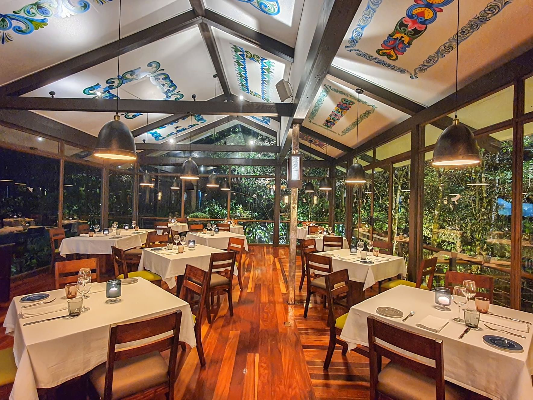 restaurant dining room with tables, chairs and floor to ceiling windows