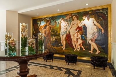 A painting of women adorns the wall in the Primer Lobby at Le Manoir Bogotá Hotel