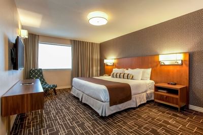 King bed with wall mounted TV.