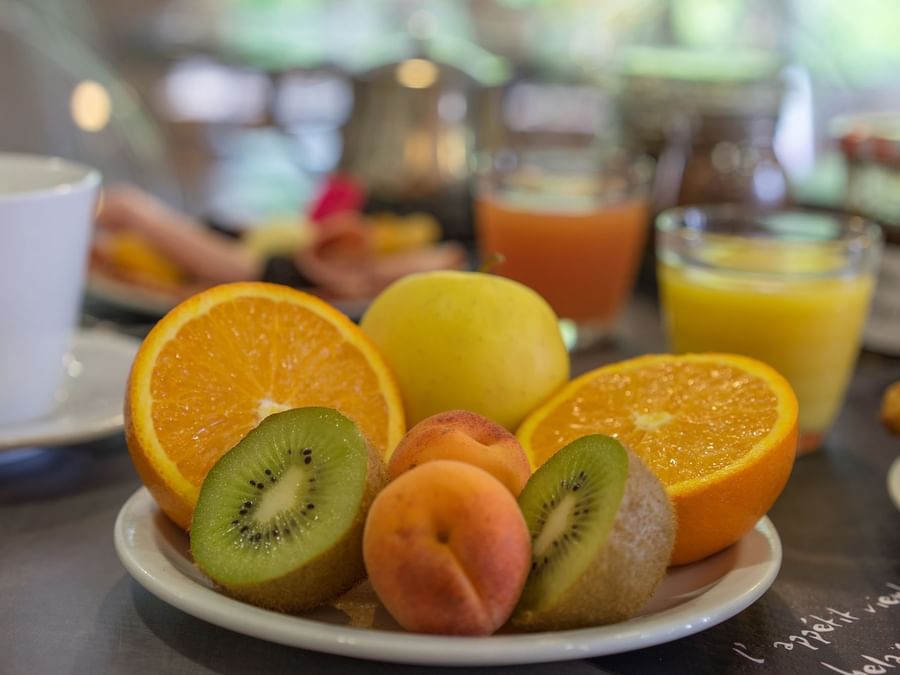 Closeup of oranges, kiwi, peach plate at Hotel Solana