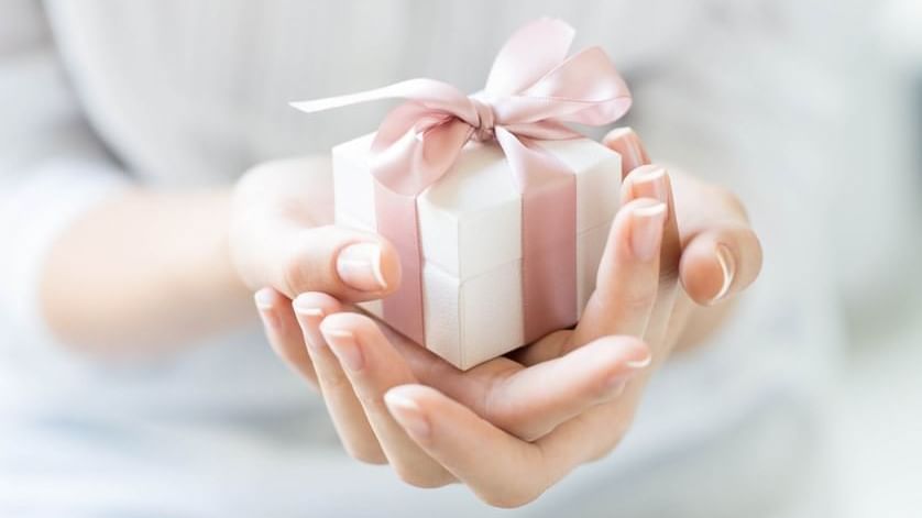 Close-up of a person holding a small gift box on hands at Pullman Port Douglas Sea Temple Resort & Spa