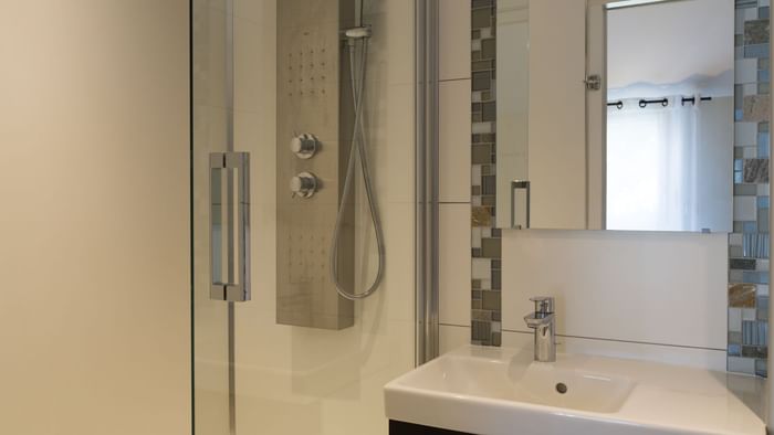 Shower & vanity in the bathroom at Hotel Au Chene Vert