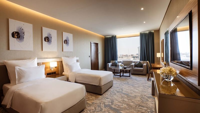 Twin bed, TV with lounge area in Superior Rooms at Cantonal Hotel by Warwick Riyadh