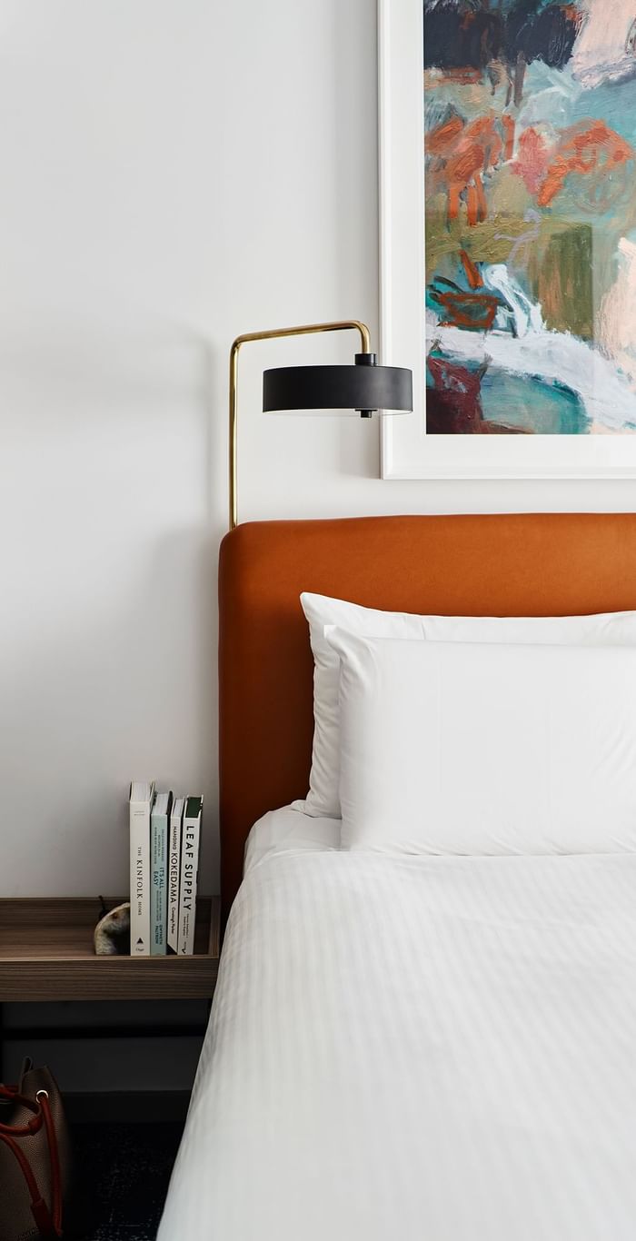 Comfy bed & lamp in a room at Novotel Sydney Darling Square