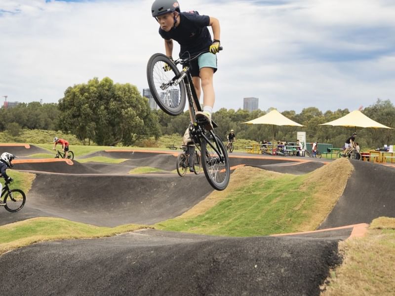 Kids riding their bicycles in Haslams Pump Track near Pullman Sydney Olympic Park