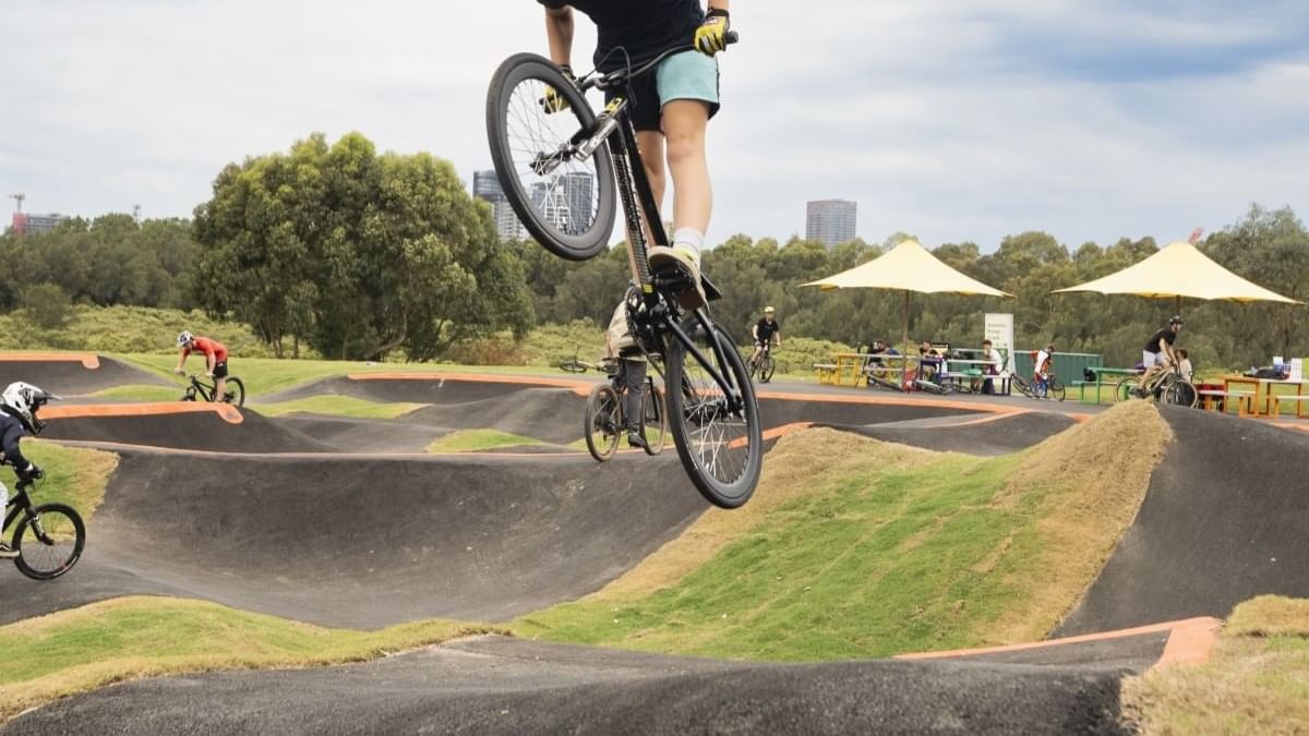 Kids riding their bicycles in Haslams Pump Track near Pullman Sydney Olympic Park