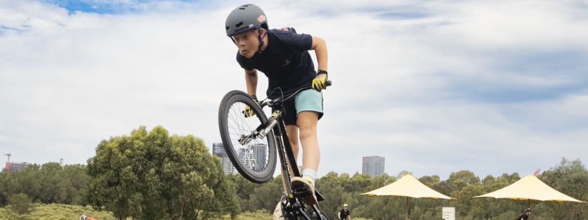Person performing a jump on a bicycle at the pump track near Novotel Sydney Olympic Park