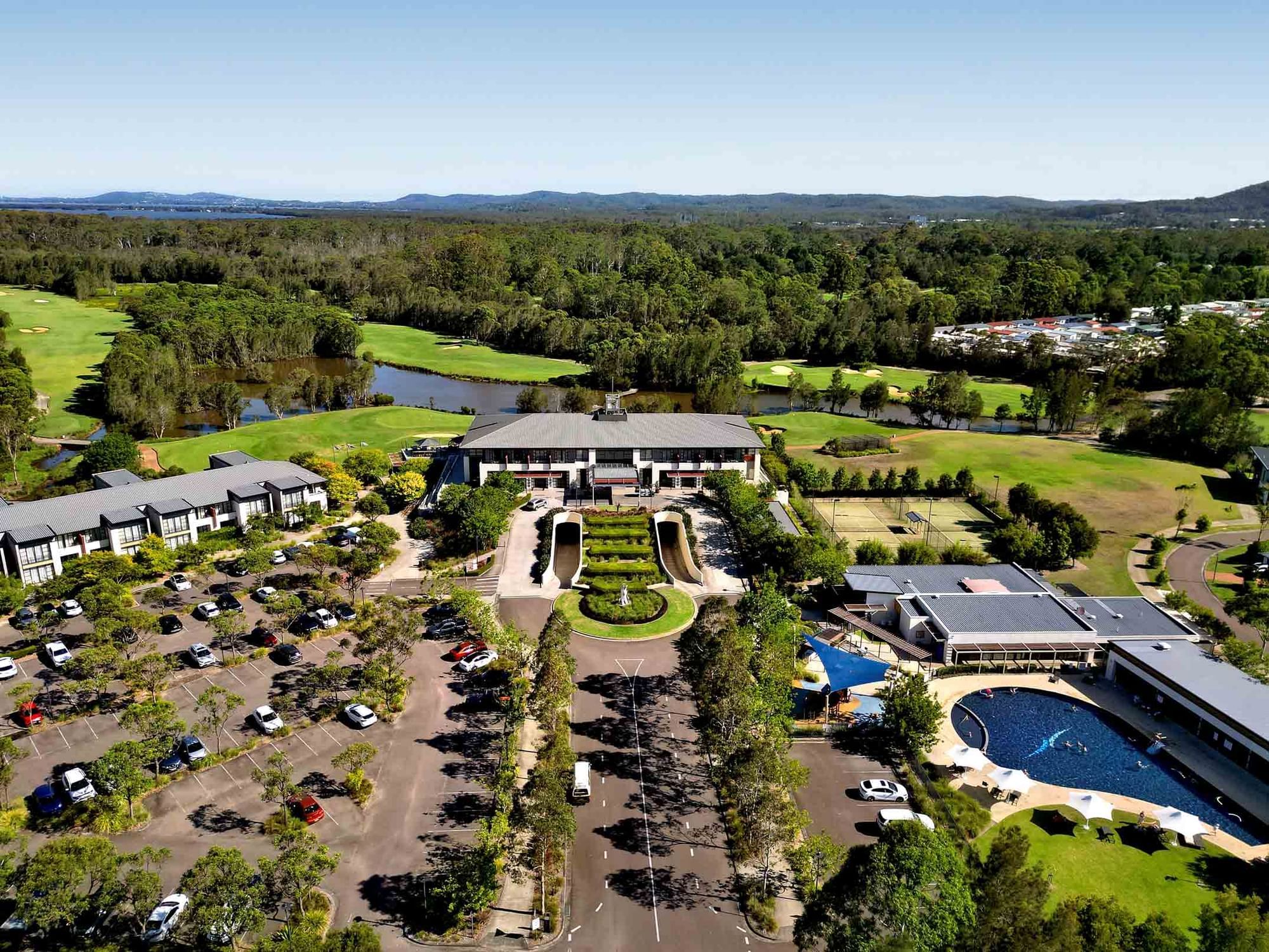 Mercure Kooindah Waters from above with pool, clubhouse and golf course
