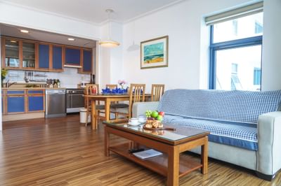 Living room with kitchen and wooden floor at Hanoi Daewoo Hotel