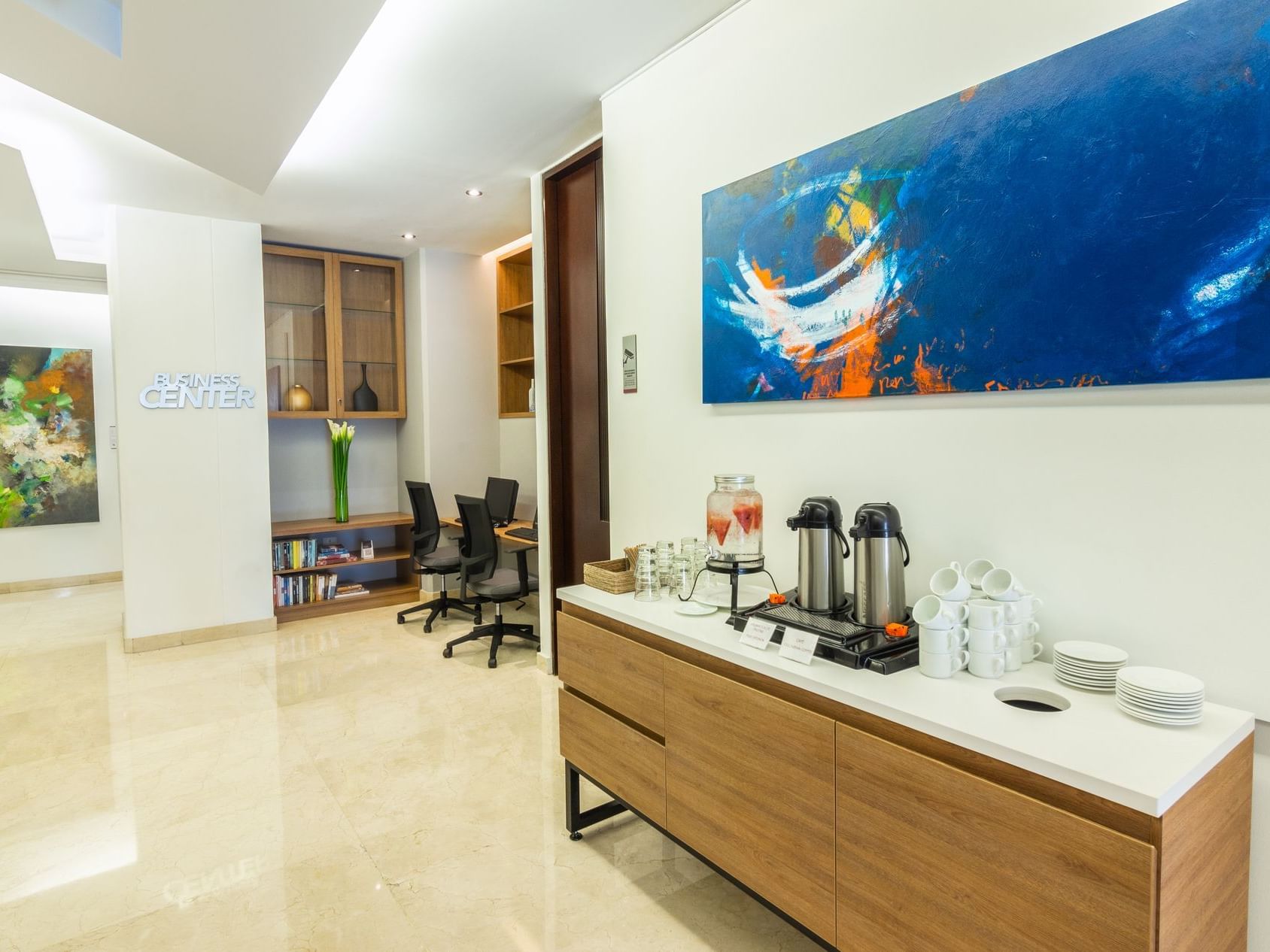 The entrance to the fitness center along with a table arranged on the side with varieties of beverages