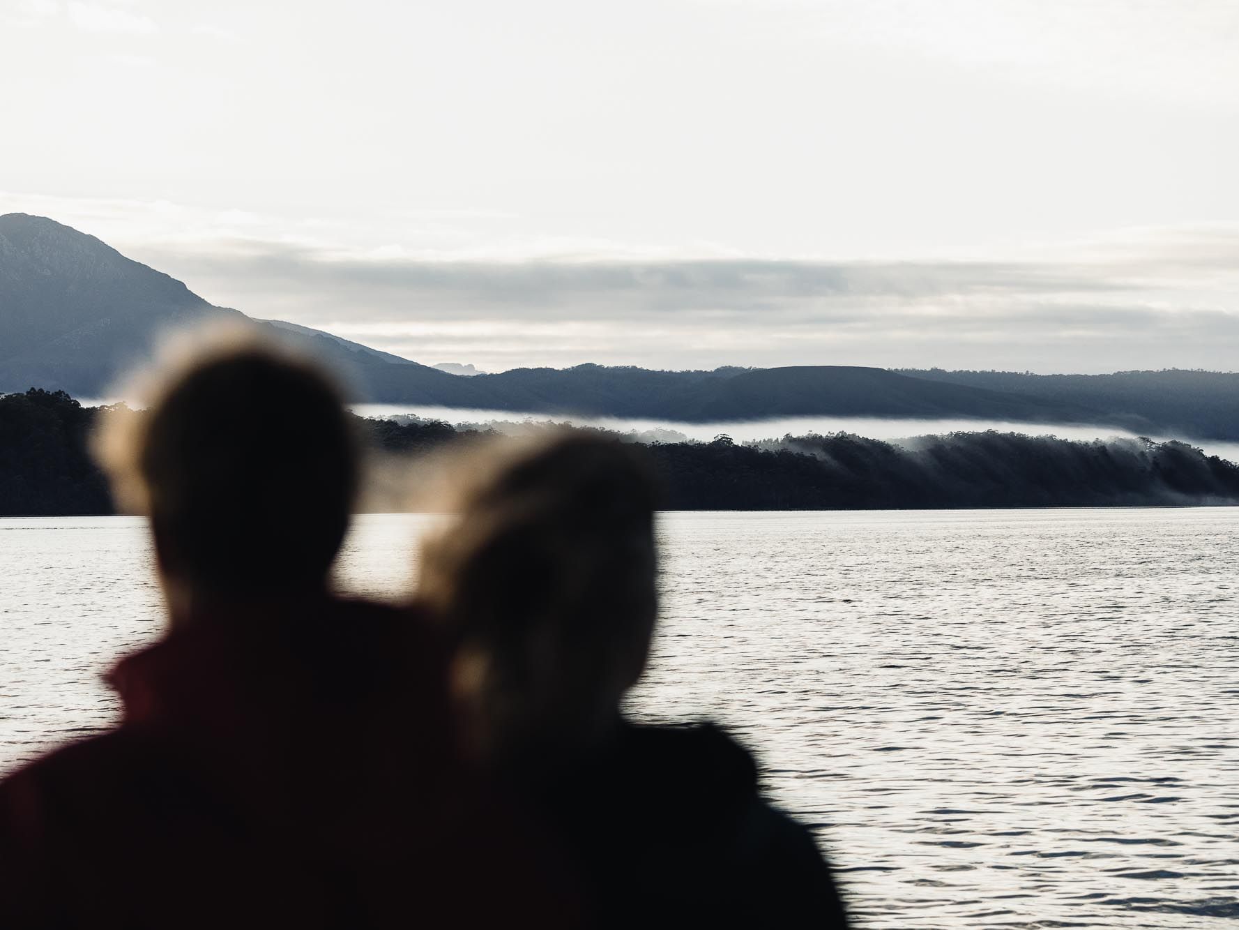 Couple looking at the Gordon River near Strahan Village 