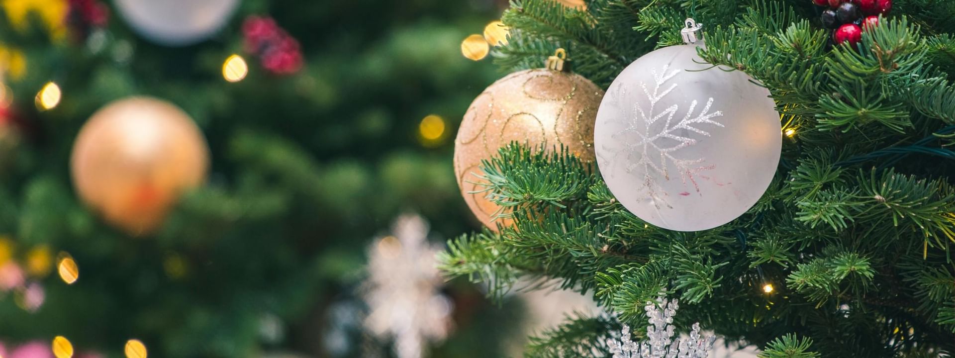 A close-up of a decorated Christmas tree featuring colorful ornaments at Warwick Hotels & Resorts