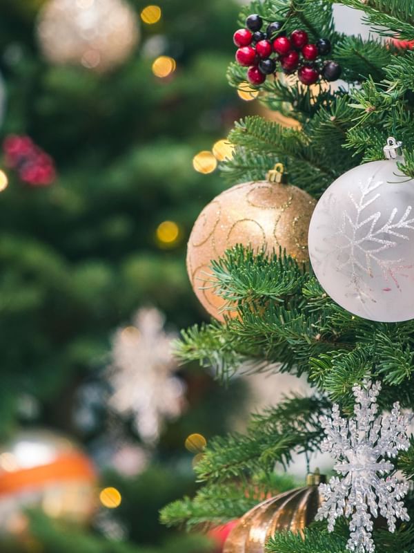 A close-up of a decorated Christmas tree featuring colorful ornaments at Warwick Hotels & Resorts