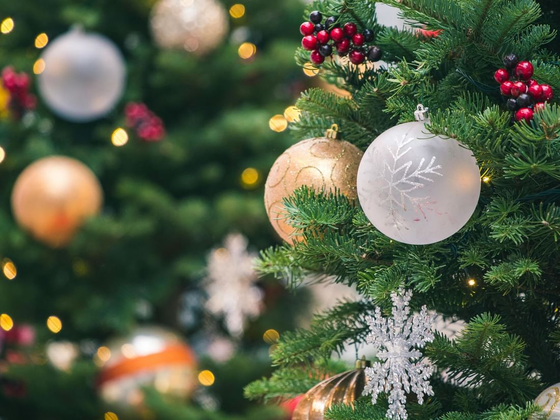 A close-up of a decorated Christmas tree featuring colorful ornaments at Warwick Hotels & Resorts