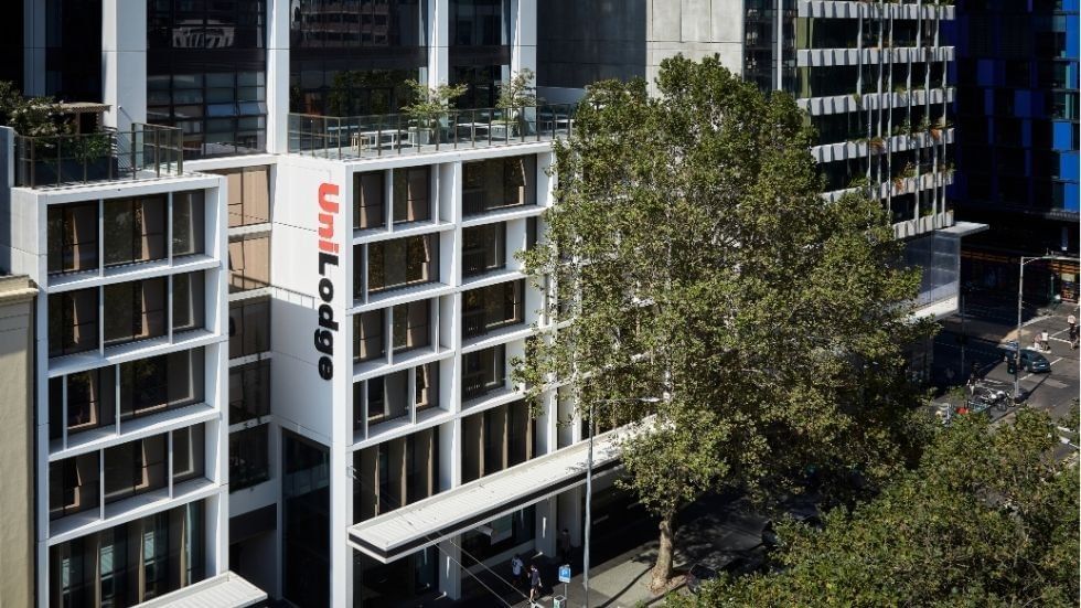 Aerial view of UniLodge Melbourne City with surrounding buildings and trees.