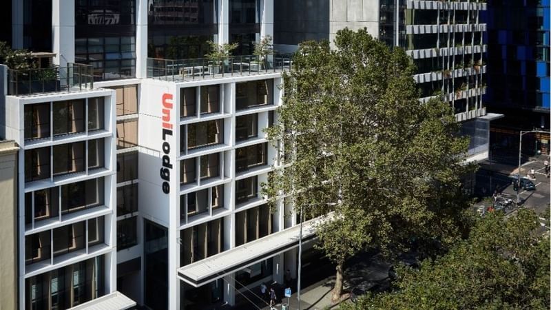Aerial view of UniLodge Melbourne City with surrounding buildings and trees.