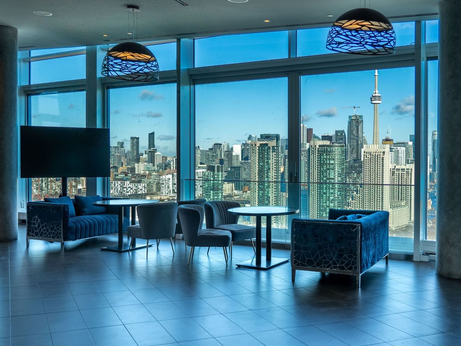 Interior of The View with large windows overlooking a city skyline at Hotel X Toronto