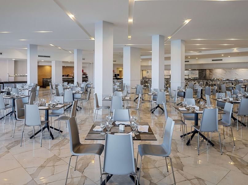 Interior of an elegant restaurant with set tables and chairs at Pickalbatros Laguna Vista Hotel in South Sinai Governorate.
