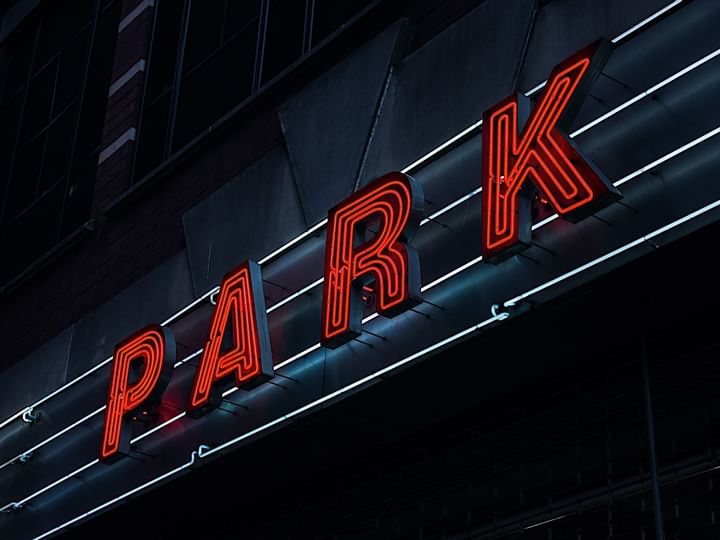 A neon sign reading 'PARK' on a building exterior