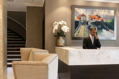 person answering phone at front desk