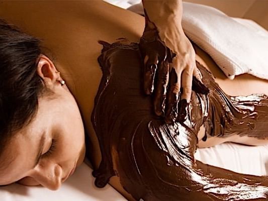 A woman getting a mud massage at Casa Colonial Beach and Spa