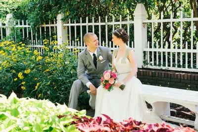 Couple Posing seated on the bench at The Venue at Portwalk
