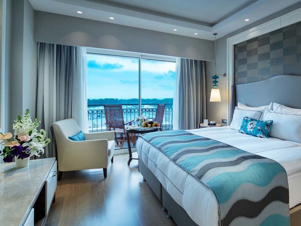 Lounger by the bed in Major Suite with wooden floors at Titanic Deluxe Golf Belek