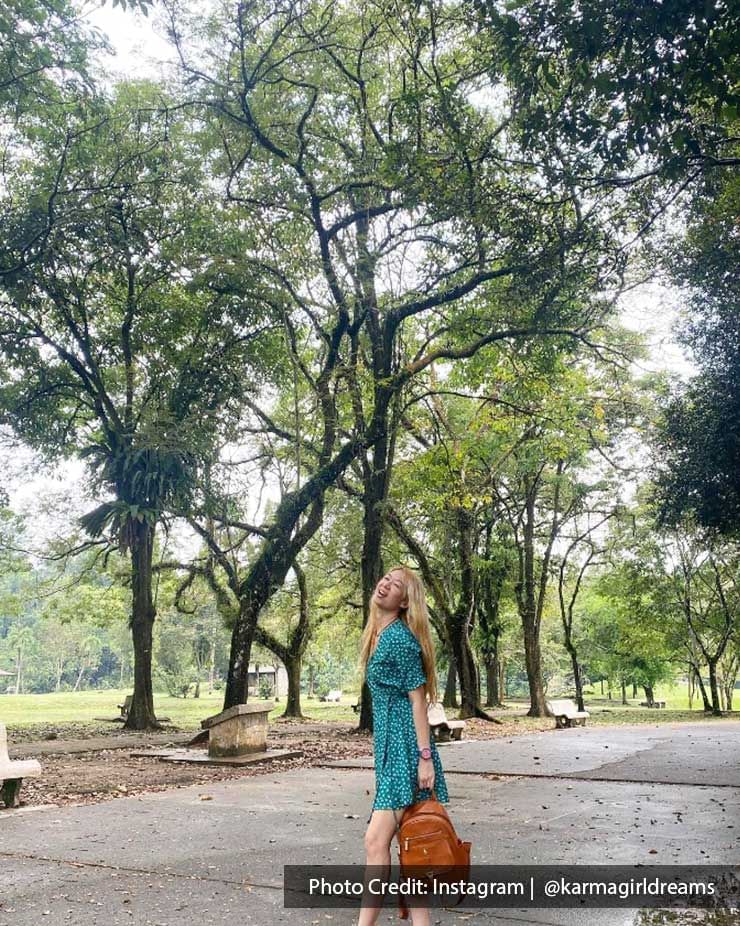 A woman was taking a picture at the Taiping Lake Gardens - Lexis Suites Penang