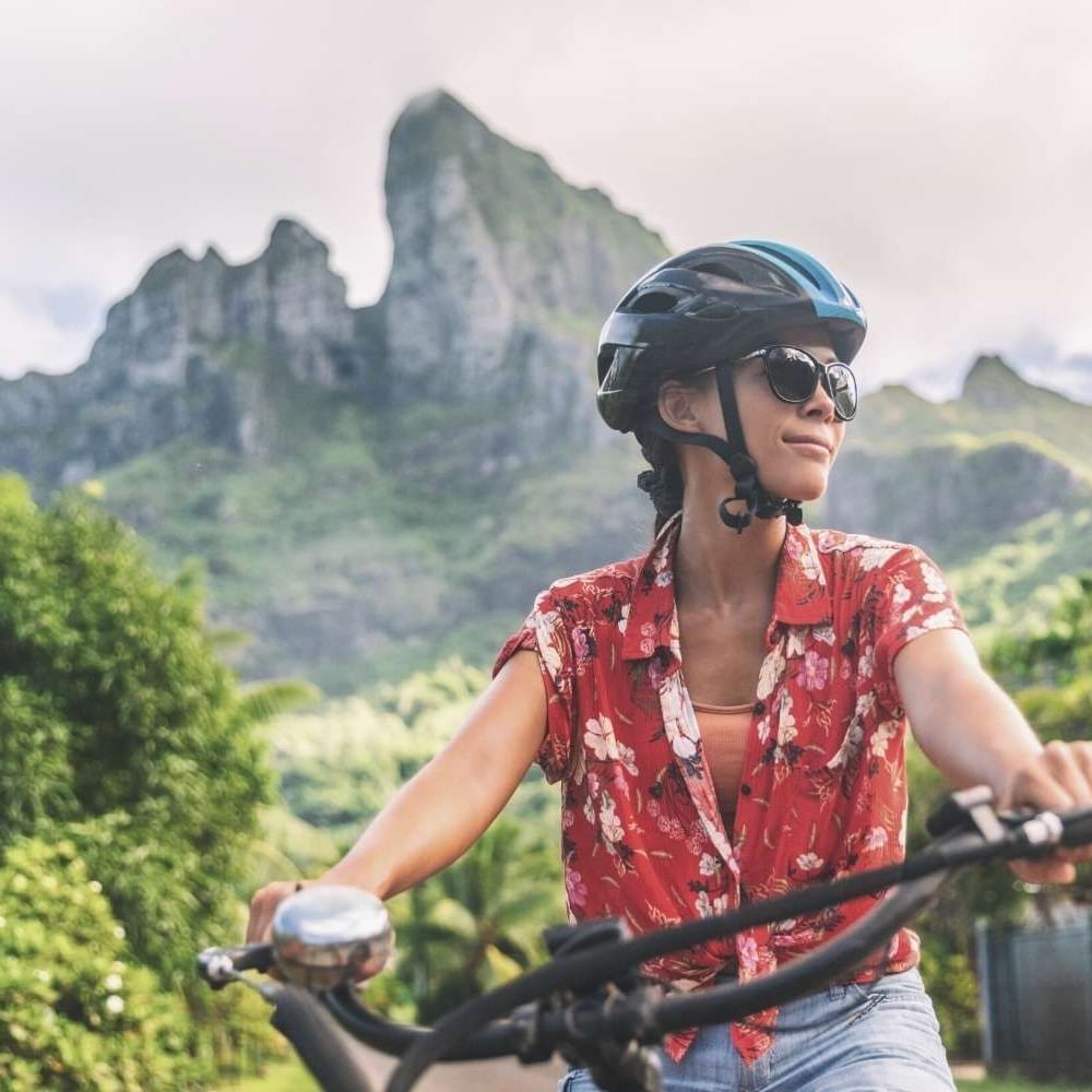 Close-up of a lady exploring the surrounding while cycling near Waikiki Resort Hotel by Sono
