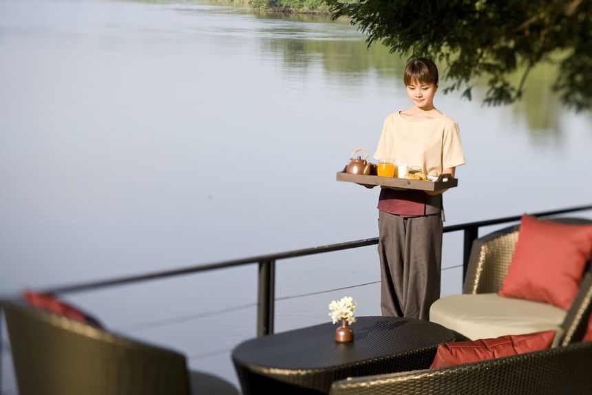 A waitress serving tea at U Hotels & Resorts