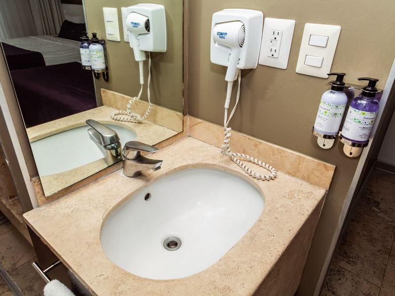Washbasin, hairdryer, soap dispenser & mirror in Deluxe Room, 2 Double at Gamma Hotels