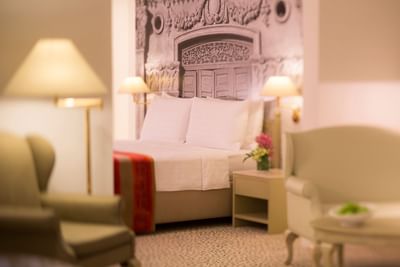 Interior of a bedroom with a king bed at Goodwood Park Hotel