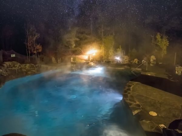 Outdoor pool area & hot tub at Sleeping Lady at night