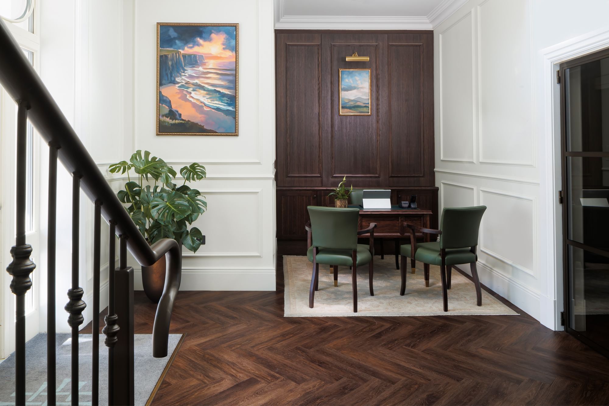 A stunning interior lobby with dark wooden floors and an elegant desk at Dunluce Lodge