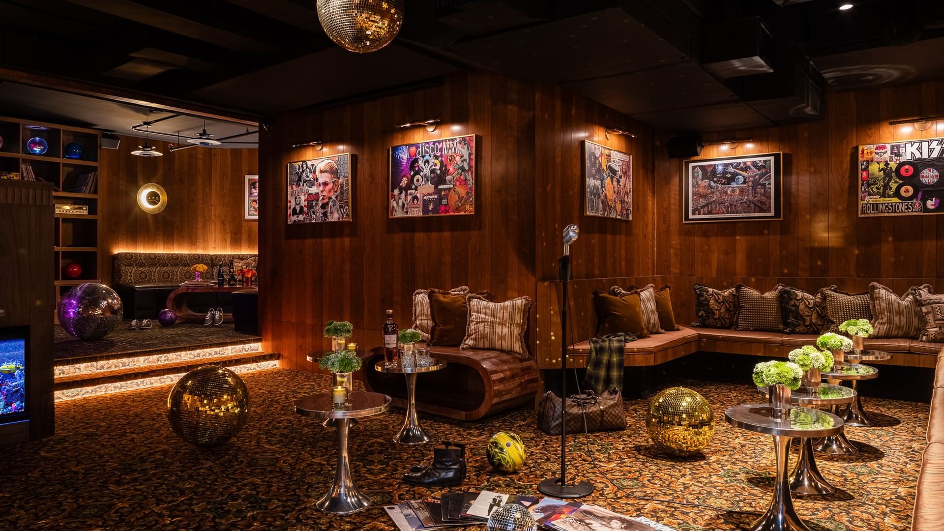 Dimes event room with wood-paneled walls, disco ball, vintage music posters, and lounge seating at Gansevoort Meatpacking NYC.
