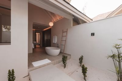 Modern 2-Bedroom Beach Villas bathroom at Ananea Madivaru Maldives with a bathtub, warm lighting, and minimalist design