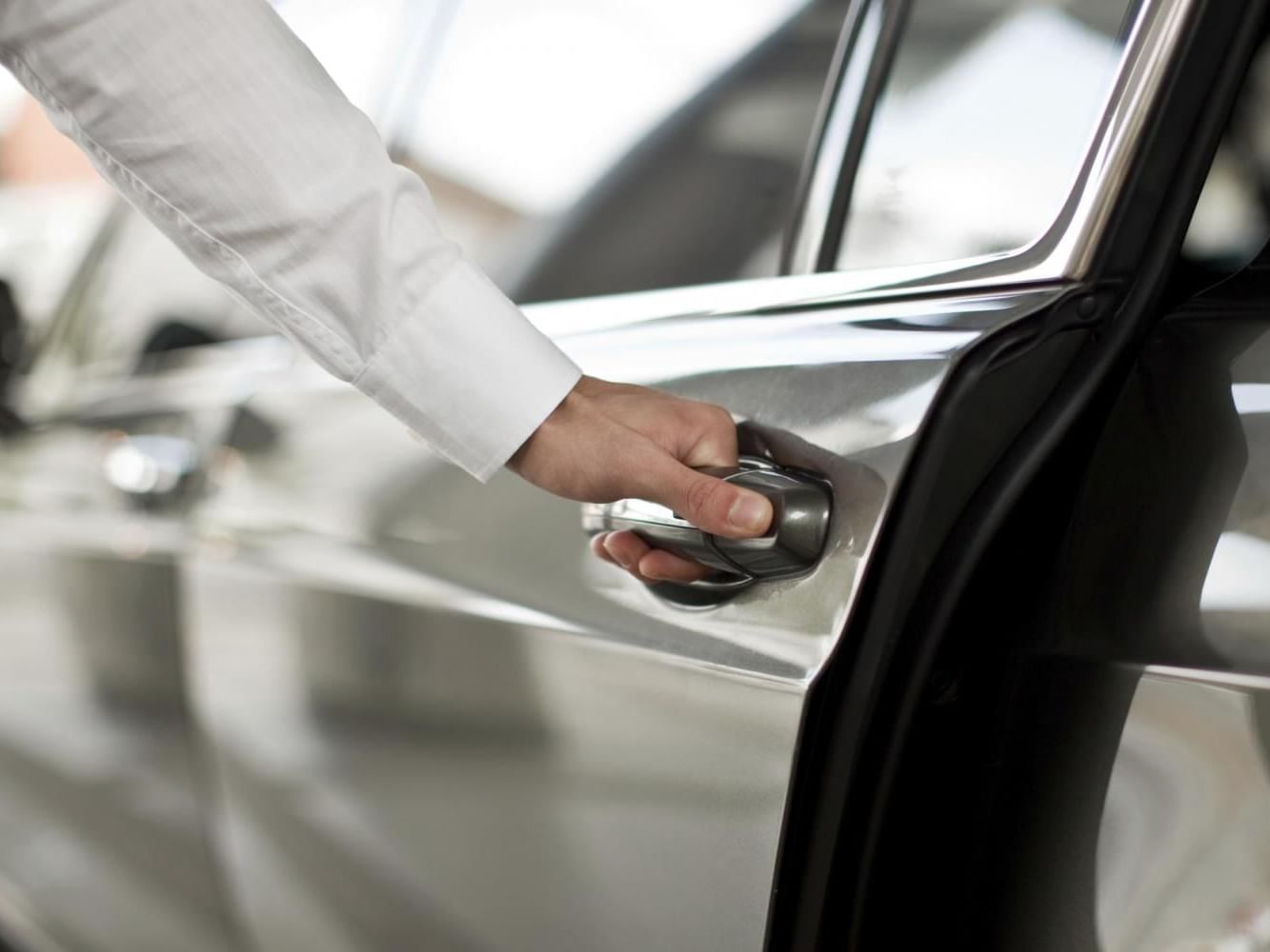 A person opening car door at Porta Hotel Antigua