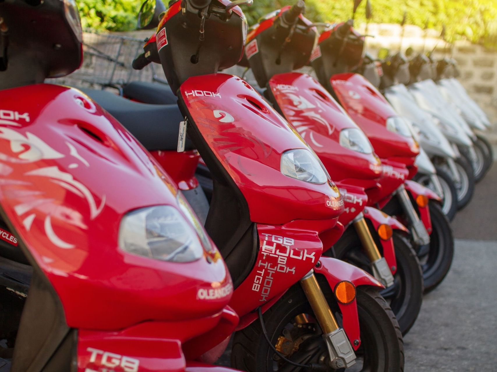 Red & white motorbikes lined at St George's Club Bermuda Hotel