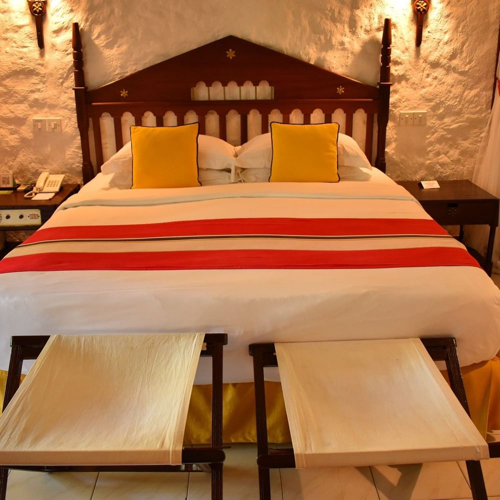 Elegant Deluxe Queen Garden View room with bright decor and wooden furniture at Serena Beach Resort & Spa in Mombasa.