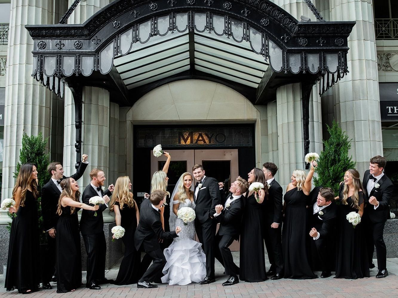 Wedded couple with friends posing outdoors at The Mayo Hotel