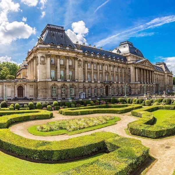 Royal Palace of Brussels with manicured hedges placed in the garden near Warwick Grand Place Brussels